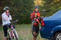 Young Couple Unmounting Mountain Bikes from Bike Rack on the Car. Adventure and Family Travel Concept. Royalty Free Stock Photo