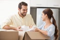 Young couple unpacking boxes in kitchen Royalty Free Stock Photo