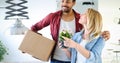 Young couple unpacking cardboard boxes at new home moving in concept Royalty Free Stock Photo