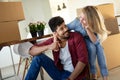 Young couple unpacking cardboard boxes at new home moving in concept Royalty Free Stock Photo