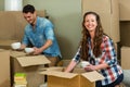 Young couple unpacking carton boxes in their new house Royalty Free Stock Photo
