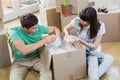 Young couple unpacking carton boxes in their new house Royalty Free Stock Photo