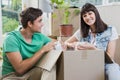 Young couple unpacking carton boxes in their new house Royalty Free Stock Photo