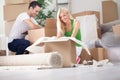 Young couple unpacking or packing boxes