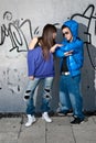 Young couple urban fashion standing portrait wall