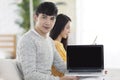 Young couple using computer together in the living room.Showing computer screen Royalty Free Stock Photo