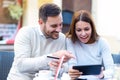 Young couple using a digital tablet and credit card for on line shopping Royalty Free Stock Photo