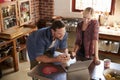 Young couple using laptop computer in kitchen, high angle Royalty Free Stock Photo