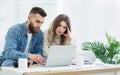 Young couple using laptop for managing expanses