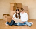 Young couple using laptop in their new home Royalty Free Stock Photo