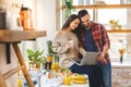 Young couple using laptop to look up recipe for their meal in kitchen Royalty Free Stock Photo