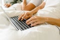 Young couple using laptop together in bed Royalty Free Stock Photo