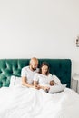 young couple using laptop together in bed Royalty Free Stock Photo