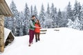 Young Couple Using Smart Phone Snowy Village Wooden Country House Man And Woman Online Messaging Winter Snow Royalty Free Stock Photo