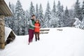 Young Couple Using Smart Phone Snowy Village Wooden Country House Man And Woman Online Messaging Winter Snow Royalty Free Stock Photo