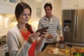 Young couple using tablet computer while cooking Royalty Free Stock Photo