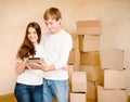 Young couple using tablet computer in their new home Royalty Free Stock Photo