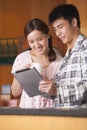 Young Couple Using Tablet in Kitchen Royalty Free Stock Photo