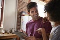 Young couple using tablet looking at each other, close up Royalty Free Stock Photo