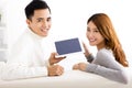 Young couple using tablet on sofa Royalty Free Stock Photo