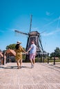 Young couple on vacation Friesland Netherlands Sloten, old town of Sloten Netherlands with canals and windmill