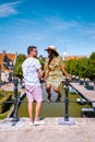 Young couple on vacation Friesland Netherlands Sloten, old town of Sloten Netherlands with canals and windmill