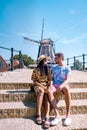 Young couple on vacation Friesland Netherlands Sloten, old town of Sloten Netherlands with canals and windmill