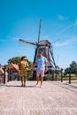 Young couple on vacation Friesland Netherlands Sloten, old town of Sloten Netherlands with canals and windmill