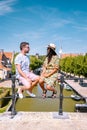 Young couple on vacation Friesland Netherlands Sloten, old town of Sloten Netherlands with canals and windmill