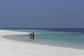 A young couple on vacation on a tropical island. White coral san