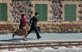 Young couple with vintage suitcase on the trainlines ready for a