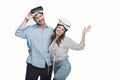 Young couple in virtual reality headsets standing embracing and smiling at camera Royalty Free Stock Photo