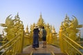 Young couple are visiting and sightseeing at Wat Rong Khun in Chiangrai