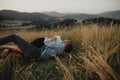 Young couple on a walk in nature in countryside, lying in grass having fun. Royalty Free Stock Photo