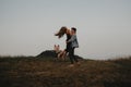 Young couple on a walk in nature at dusk in countryside, having fun hugging. Royalty Free Stock Photo