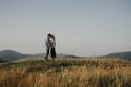 Young couple on a walk in nature at sunset in countryside, kissing. Royalty Free Stock Photo