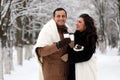 A young couple walk in a winter park Royalty Free Stock Photo