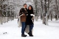 A young couple walk in a winter park Royalty Free Stock Photo