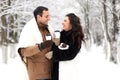 A young couple walk in a winter park Royalty Free Stock Photo