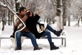 A young couple walk in a winter park Royalty Free Stock Photo