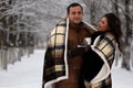 A young couple walk in a winter park Royalty Free Stock Photo
