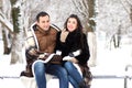 A young couple walk in a winter park Royalty Free Stock Photo