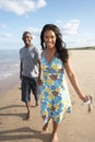 Young Couple Walking Along Shoreline