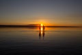 Young couple is walking away in the water on summer beach. Sunset over the sea.Two silhouettes against the sun. Just married Royalty Free Stock Photo