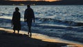 A Young Couple Walking On The Beach During The Sunset - Waves Coming to the Shore Royalty Free Stock Photo