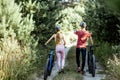 Young couple walking with bicycles outdoors Royalty Free Stock Photo