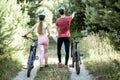 Young couple walking with bicycles outdoors Royalty Free Stock Photo