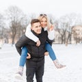 Young couple walking through the city. The guy carries the girl Royalty Free Stock Photo