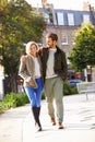 Young Couple Walking Through City Park Together Royalty Free Stock Photo