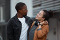 Young couple walking in the city on the street, holding hands and in love. Dating, love and black woman with black man